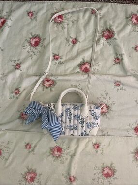 Nanette Lepore White Mini Floral Crossbody with Blue Bow Accent